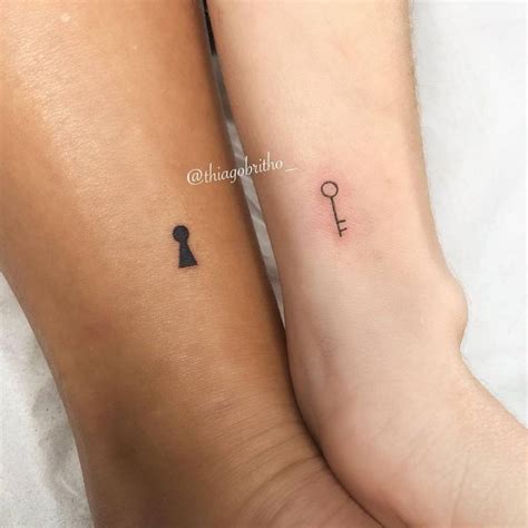 Matching key and keyhole tattoo for sisters.