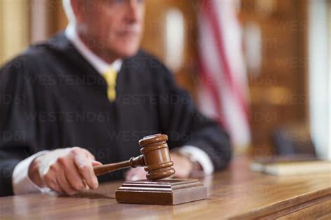Judge banging gavel in court stock photo