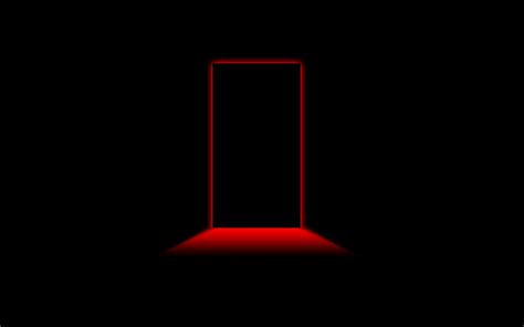 an open door in the dark with red light coming from it