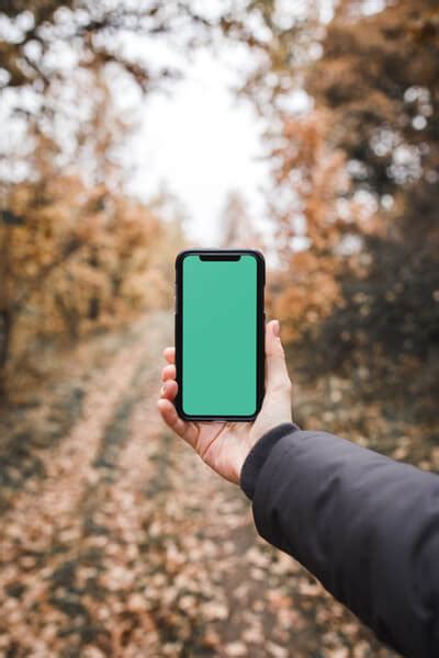 Free mockup: Man holding iPhone X