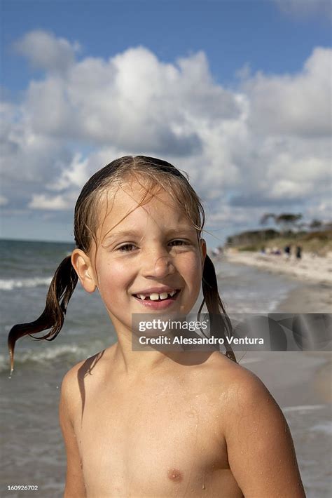 Portrait Of Young Girl On Beach Stock Photo | Getty Images