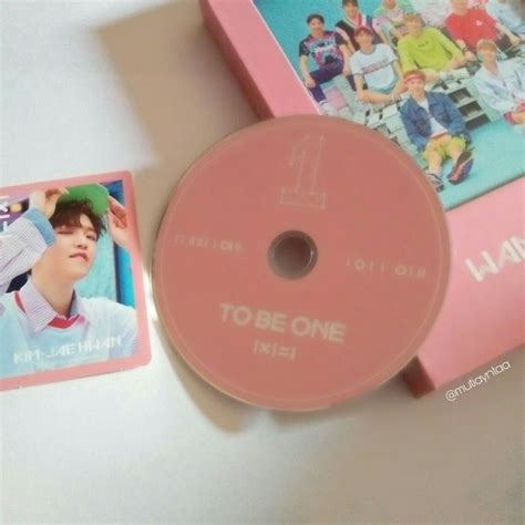 a pink dvd case sitting on top of a table next to a card and an album