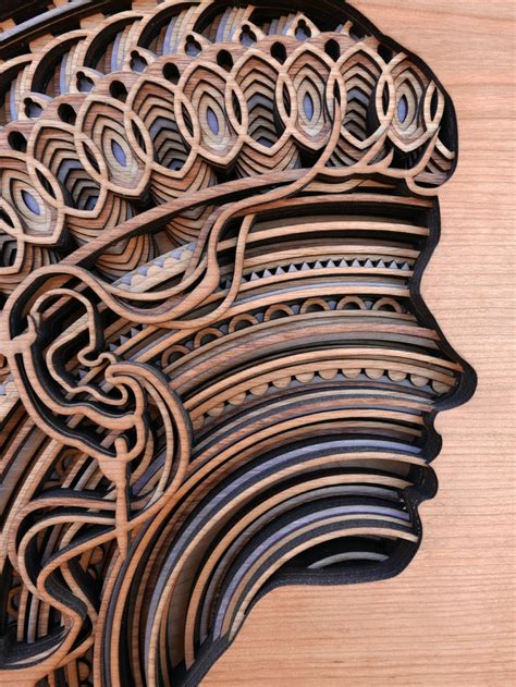 Layers of intricate patterns are featured in mesmerising laser-cut wood sculptures ...