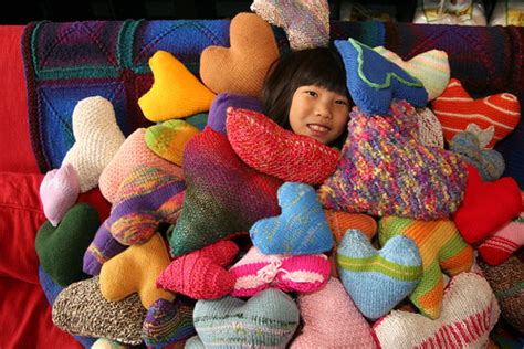 Girl Buried by Knitted Pillows Hearts for Haiti Celebratio… | Flickr
