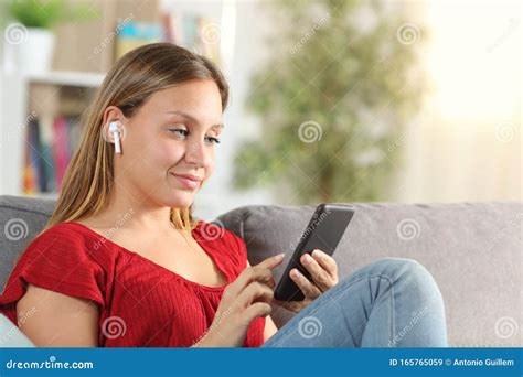Lady Listening To Music with Phone and Wireless Earbuds Stock Image - Image of buds, cell: 165765059