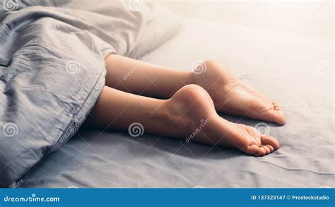 Female Beautiful Feet Under Blanket in Bed Stock Image - Image of footcare, morning: 137323147