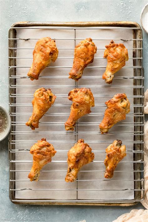 Overhead photo of baked salt and vinegar chicken wings on a wire rack lined sheet pan - photo of ...