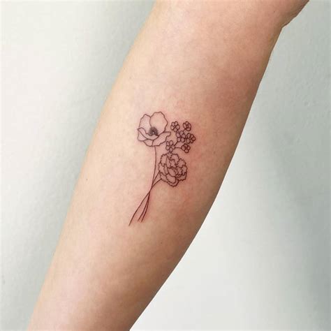 Tattoo of a fine line flower bouquet located on the
