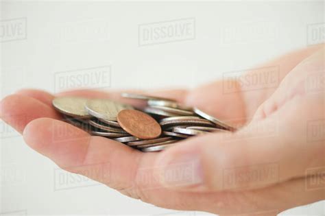 Hand holding coins - Stock Photo - Dissolve