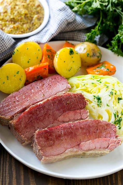 A plate of sliced corned beef with cabbage, carrots and potatoes ...