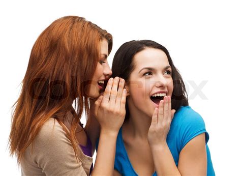 two smiling girls whispering gossip | Stock image | Colourbox