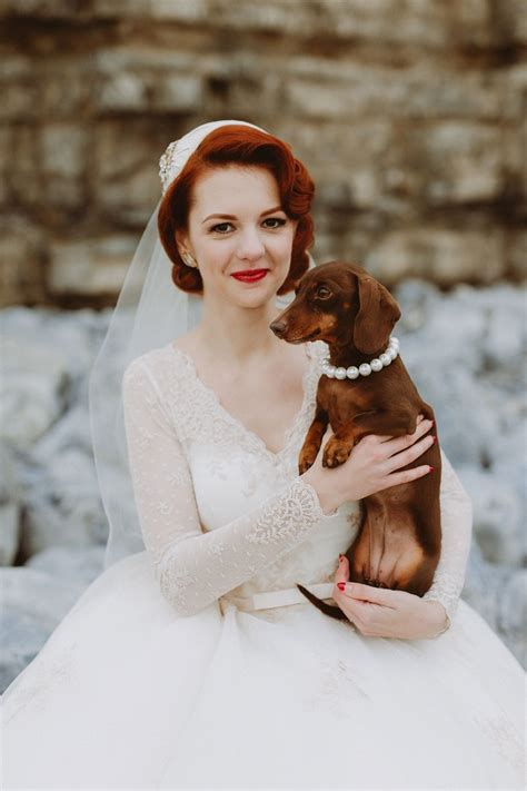 A little Dachsund wedding dog guest wearing a pearl necklace. Image by Emily & Steve. Wedding ...