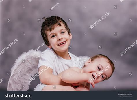 Boy Wearing Angel Wings Embraces Small Stock Photo 1968567901 ...