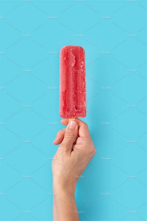 Hand Holding a Strawberry Popsicle