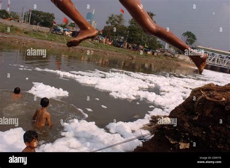 Boys swim in polluted river at slum area in Jakarta Stock Photo, Royalty Free Image: 42521001 ...