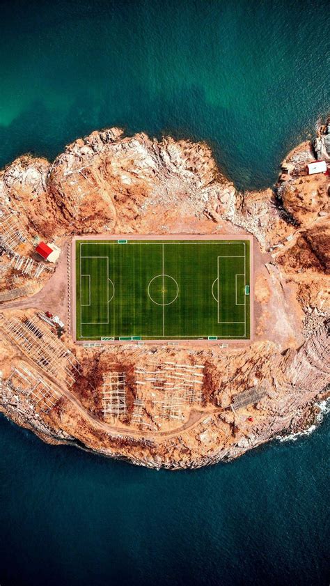 an aerial view of a soccer field in the ocean