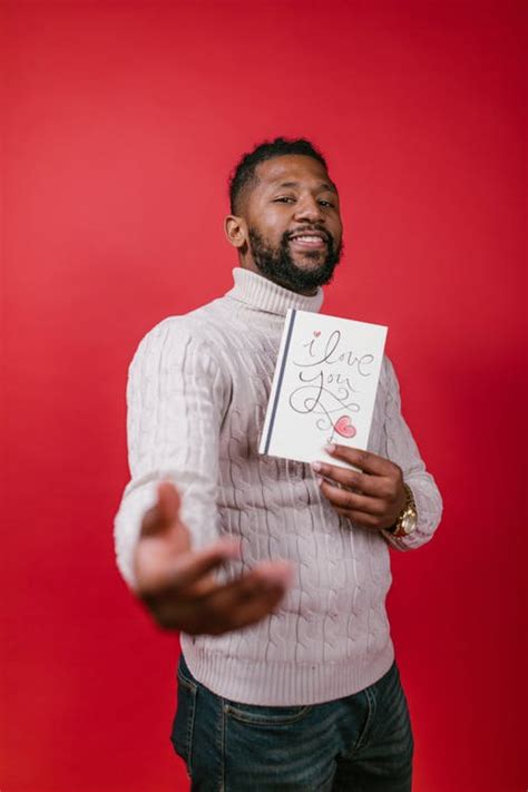 Man in White Long Sleeve Shirt Holding Valentine's Day Card · Free Stock Photo