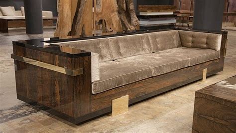 a couch and table in a room with wooden furniture on the floor next to each other