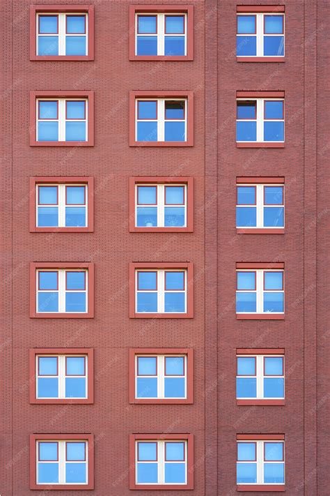 Premium Photo | Windows of a brick building texture.