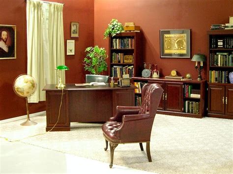 an office with a desk, chair and bookshelf in the corner is shown