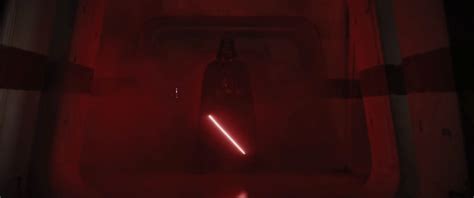 a red light shining through a dark room with a bottle in the foreground and a star wars logo on ...