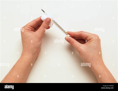 Cleaning thermometer with cotton wool Stock Photo - Alamy