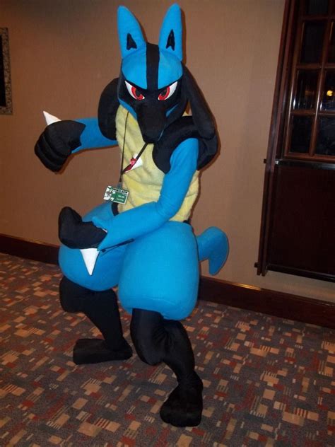 an inflatable pokemon costume is standing on one leg and holding onto the tail of another