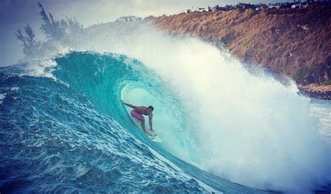 a man riding a wave on top of a surfboard