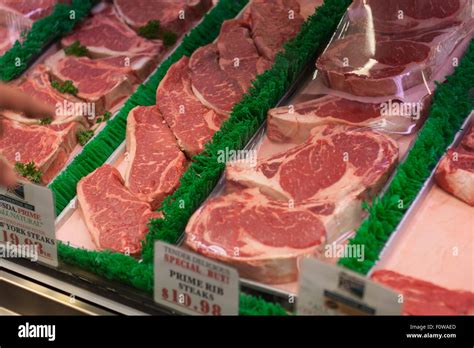 Steak in glass display case Stock Photo - Alamy