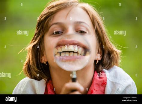 Teenage with magnifying glass Stock Photo - Alamy