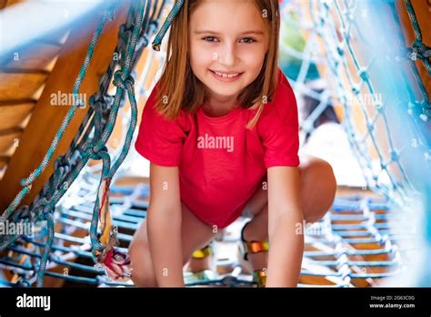 Little girl playing on climbing net on park playground Stock Photo - Alamy