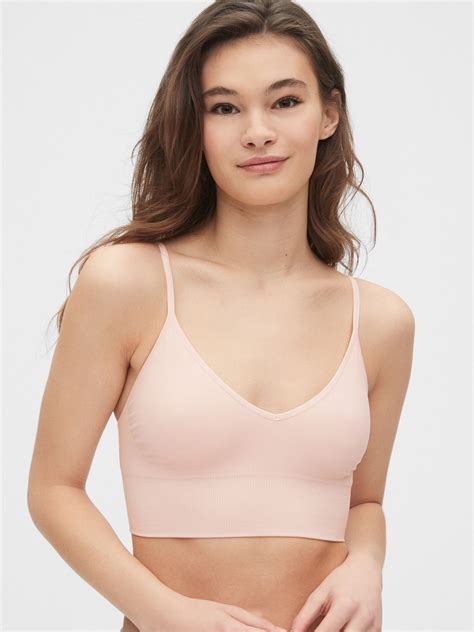 Soft, seamless knit. Plunge neckline. Adjustable straps. For more fit and sizing info, check out ...