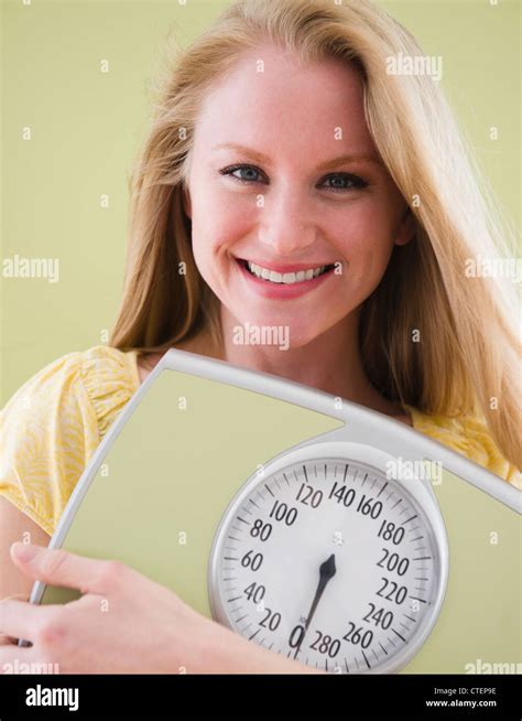 USA, New Jersey, Jersey City, Woman holding bathroom scale Stock Photo - Alamy