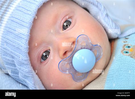 Baby with a dummy Stock Photo - Alamy