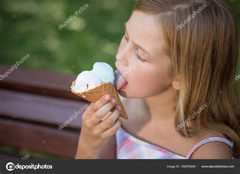 Little girl eating ice cream. Stock Photo by ©svyatoslavlipik 162876494