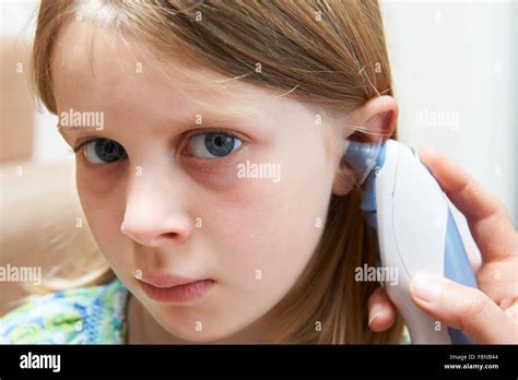 Girl Having Temperature Taken With Digital Thermometer Stock Photo - Alamy