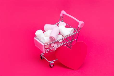 Premium Photo | Small grocery cart full of sweet marshmallow candies. Give gifts with love on ...