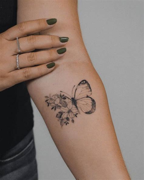 Half butterfly half flower tattoo done on the inner