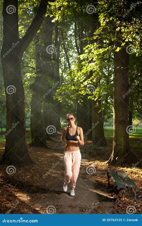 Woman jogging in the park stock image. Image of muscular - 20763125