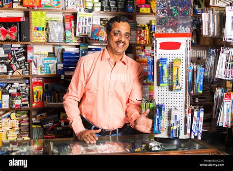 1 Indian Shopkeeper Man Showing Pens In Stationery Shop Stock Photo - Alamy