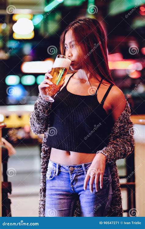 Young Beautiful Woman Drinking Beer in a Bar Stock Image - Image of nice, nightlife: 90547271