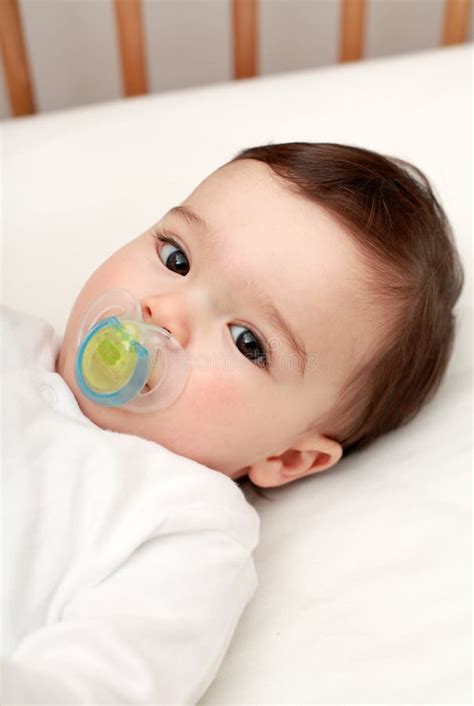 Beautiful baby with dummy stock image. Image of adorable - 24725587