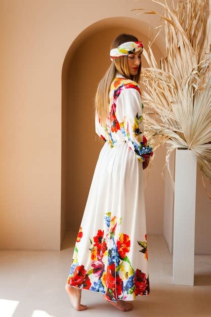 Premium Photo | A woman in a white dress with a floral pattern on it