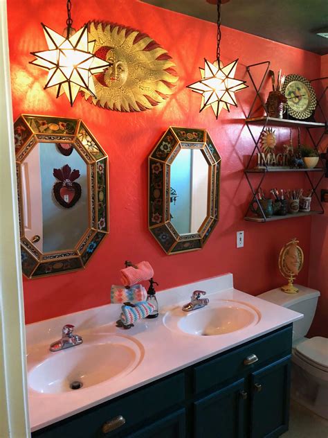 a bathroom with two sinks and three mirrors on the wall above them is decorated with gold stars