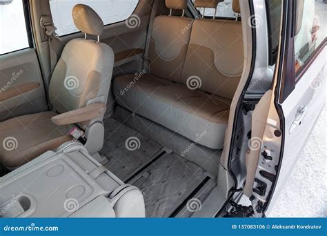 The Interior of the Car in the Back of a Minivan with a Wide Open Automatic Door and a View of ...