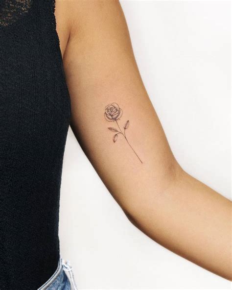 Fine line rose tattoo located on the inner arm.