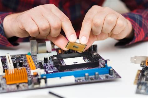 Premium Photo | Close-up person installing cpu on motherboard