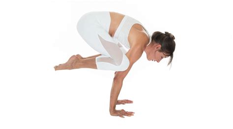 a woman in white is doing yoga poses