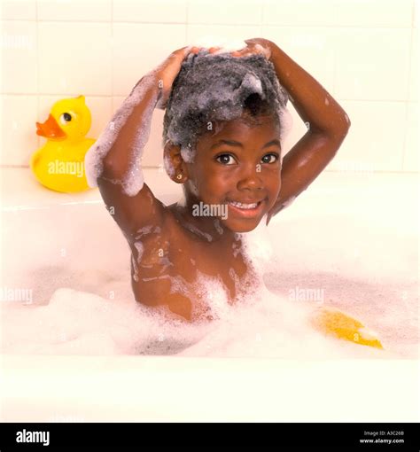 Young African American girl taking a bubble bath with her hands Stock Photo: 246379 - Alamy