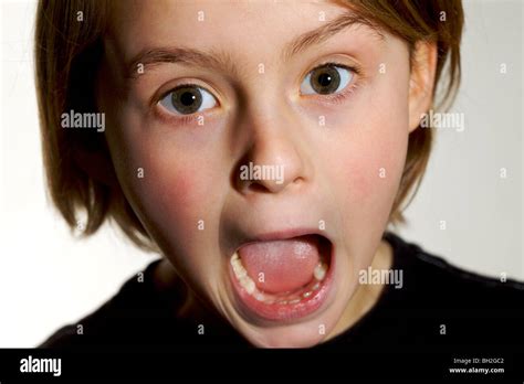 Young girl shouting screaming shocked alarmed scared surprised quizzical pull a face Stock Photo ...